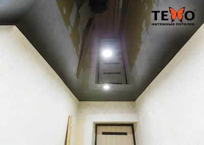 Черный глянцевый натяжной потолок с точечными светильниками в коридоре